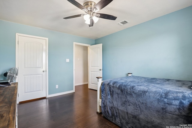 bedroom with dark hardwood / wood-style flooring and ceiling fan