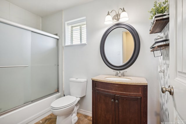 full bathroom featuring bath / shower combo with glass door, vanity, and toilet