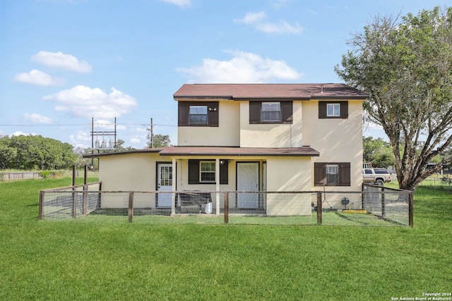 back of property featuring a lawn