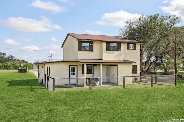 back of house with a yard and a patio