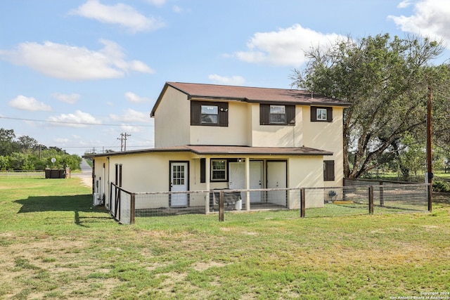 back of property with a yard and a patio area