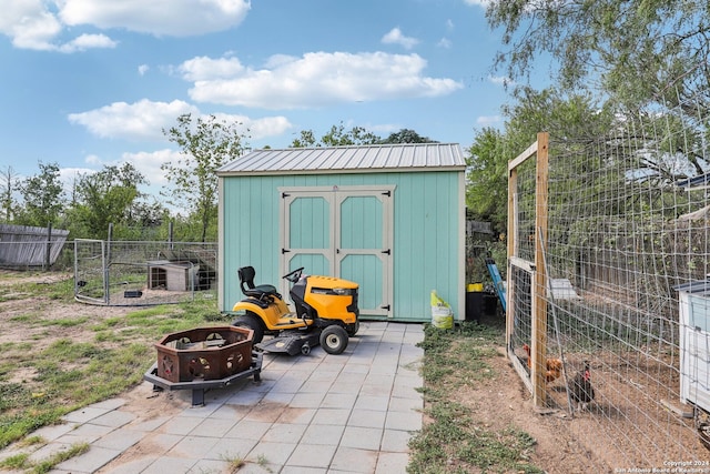 view of outbuilding with a fire pit