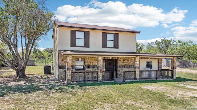 view of front of house featuring cooling unit, a porch, and a front yard