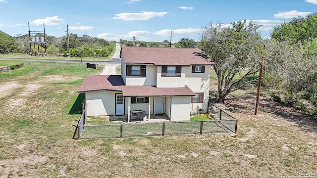 back of property with a lawn