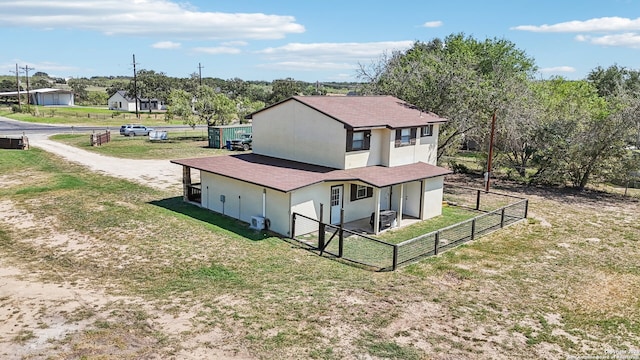 rear view of property with a yard