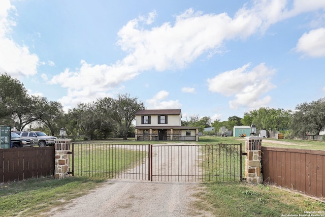 view of gate with a yard