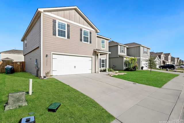 view of front of property featuring a front yard and a garage