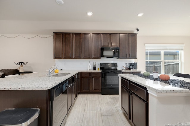 kitchen featuring backsplash, black appliances, kitchen peninsula, and sink