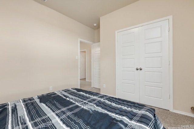 bedroom with carpet and a closet