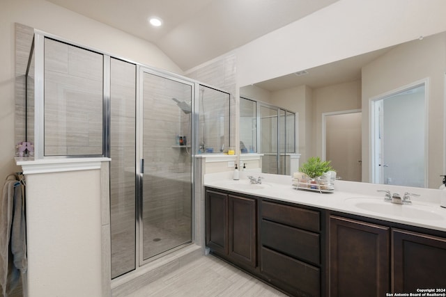 bathroom featuring vaulted ceiling, walk in shower, and vanity