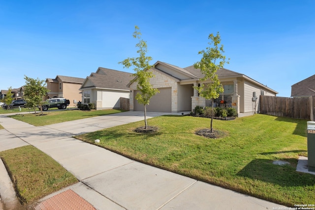 ranch-style home with a garage and a front lawn