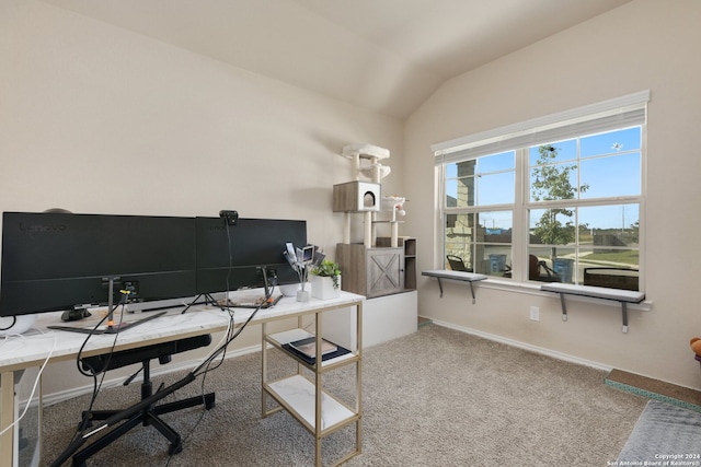 carpeted home office featuring vaulted ceiling