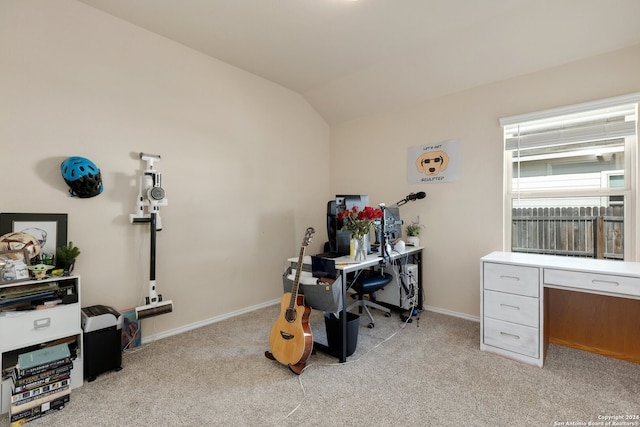 carpeted office space with vaulted ceiling