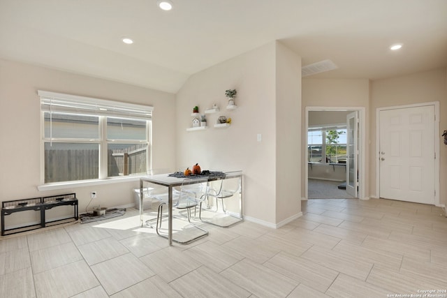 dining area featuring vaulted ceiling