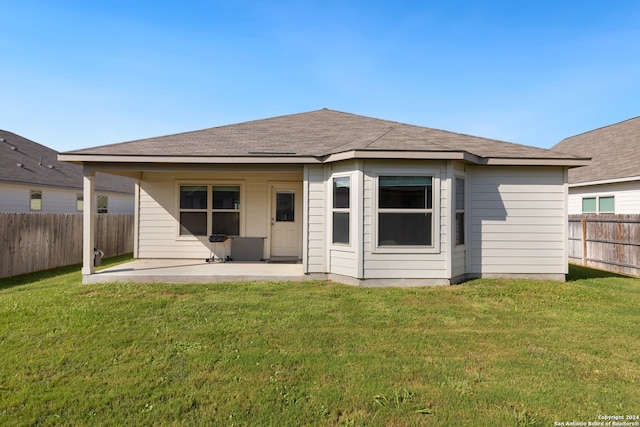 back of property featuring a lawn and a patio area