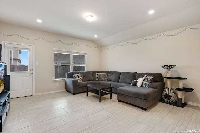 living room featuring lofted ceiling