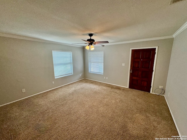 carpeted empty room featuring ceiling fan, a textured ceiling, and ornamental molding