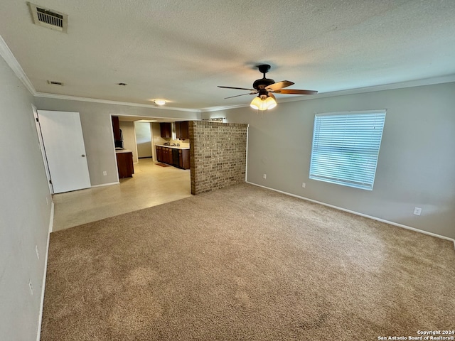 interior space featuring a textured ceiling, ornamental molding, and ceiling fan