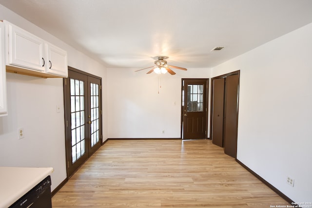 interior space featuring light wood-type flooring, ceiling fan, and french doors