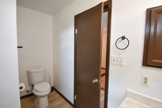 bathroom featuring hardwood / wood-style floors and toilet