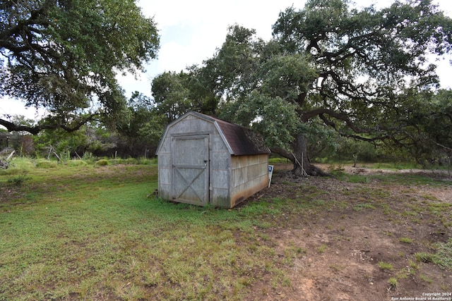 view of outbuilding with a lawn