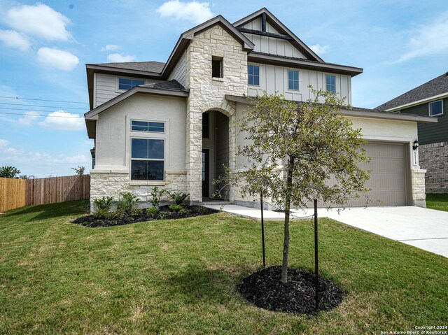 craftsman-style house with a front yard and a garage