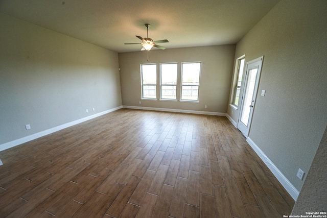 unfurnished room with ceiling fan and dark hardwood / wood-style floors