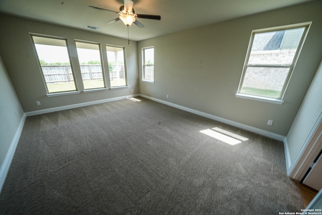 carpeted spare room with ceiling fan