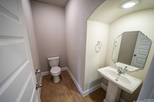 bathroom featuring sink, hardwood / wood-style flooring, and toilet