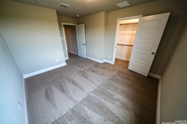 unfurnished bedroom with a closet and carpet floors