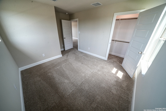 unfurnished bedroom with a closet and carpet floors