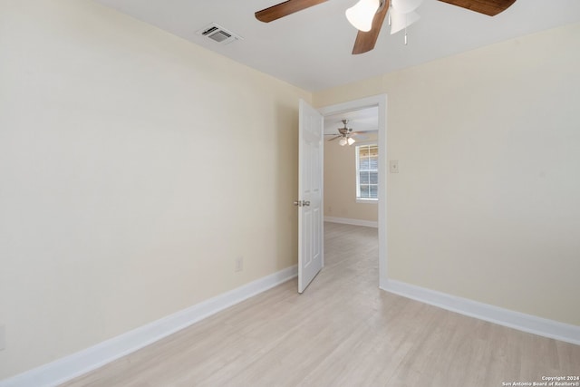 spare room featuring light hardwood / wood-style floors and ceiling fan