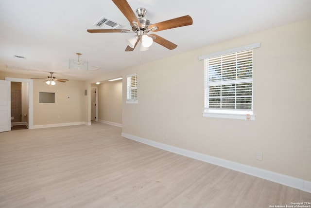 empty room with light wood-type flooring and ceiling fan