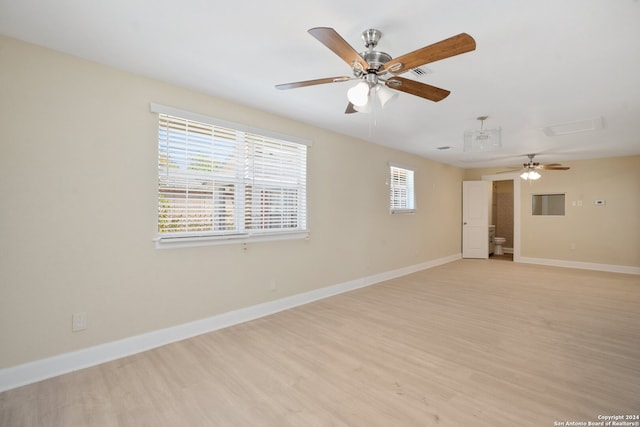 spare room with light wood-type flooring and ceiling fan