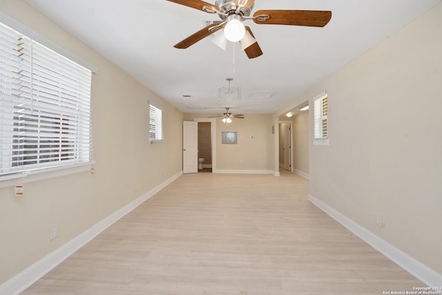 empty room with light hardwood / wood-style floors and ceiling fan