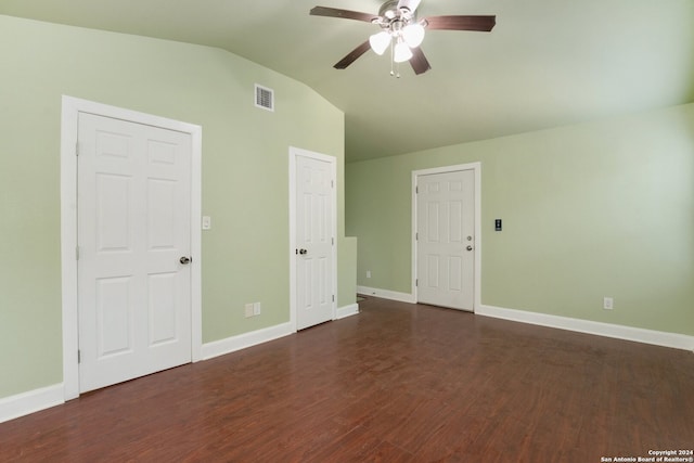 unfurnished bedroom featuring lofted ceiling, ceiling fan, and dark wood-type flooring