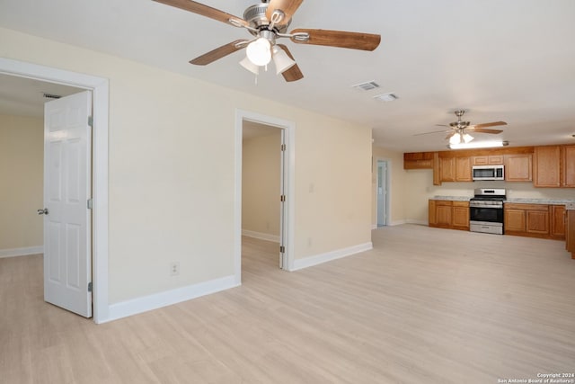 kitchen featuring light hardwood / wood-style floors, ceiling fan, and appliances with stainless steel finishes