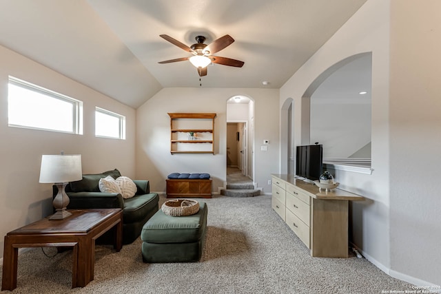 living room with ceiling fan, light carpet, and vaulted ceiling