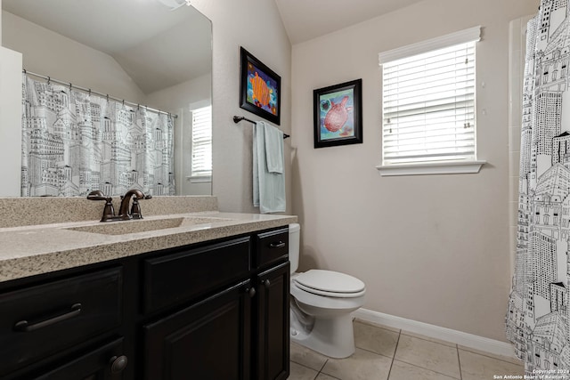 bathroom featuring a healthy amount of sunlight, toilet, vanity, and vaulted ceiling