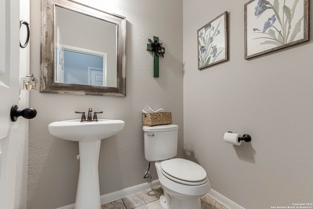 bathroom featuring toilet and tile patterned floors