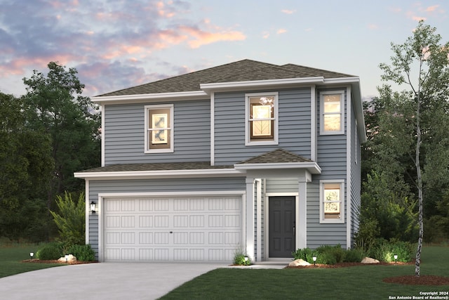 view of front facade with a lawn and a garage