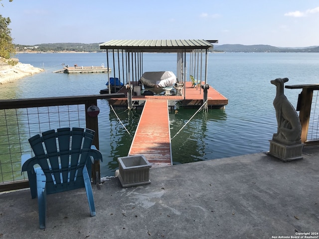 view of dock featuring a water and mountain view