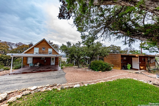 view of front of house with a front yard and a carport