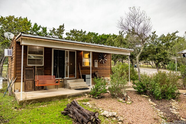 rear view of property with a porch