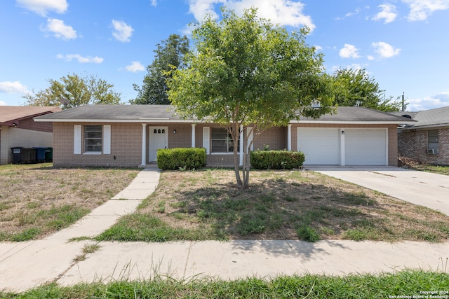 ranch-style home with a garage and covered porch