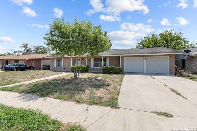 ranch-style home with a garage and a front yard