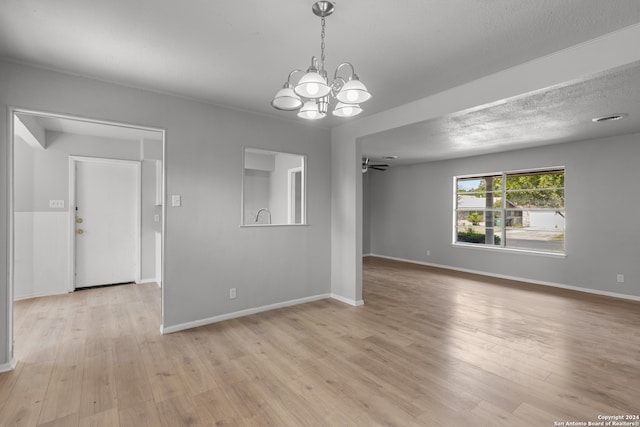 interior space featuring a chandelier, light hardwood / wood-style floors, and a textured ceiling