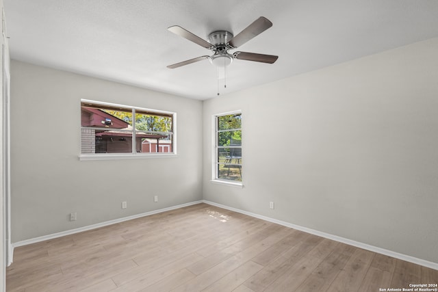 unfurnished room with ceiling fan and light wood-type flooring