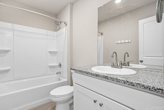 full bathroom featuring shower / bathing tub combination, vanity, hardwood / wood-style floors, and toilet