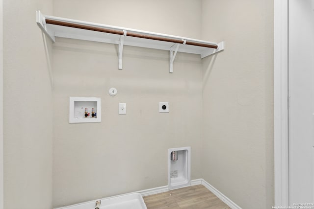 laundry room with washer hookup, hookup for a gas dryer, light hardwood / wood-style floors, and electric dryer hookup